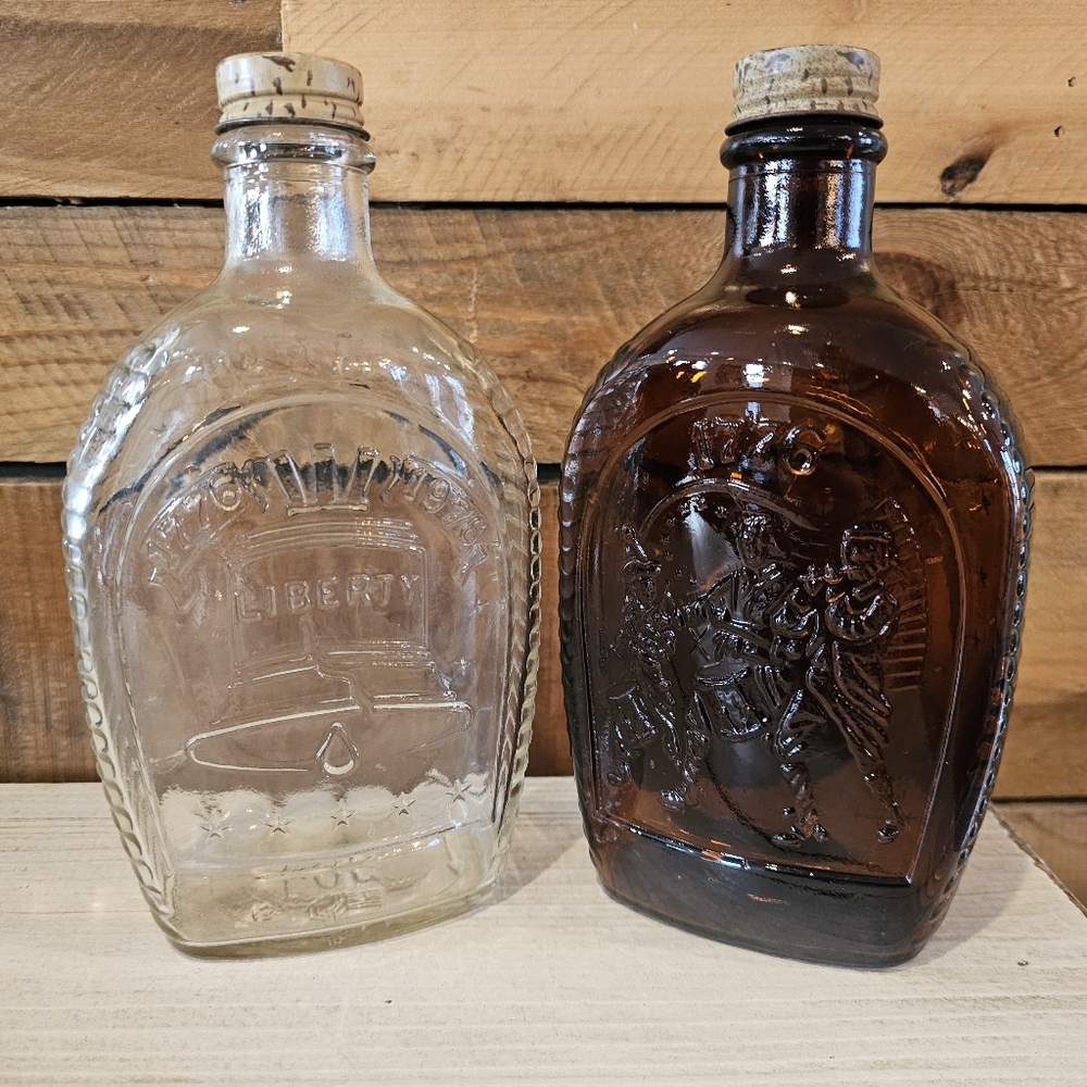 Two Vintage '76 Bicentennial Log Cabin Syrup Collectible Bottles Clear & Amber